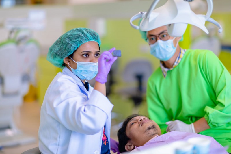 Student observing dental procedures by lecturers