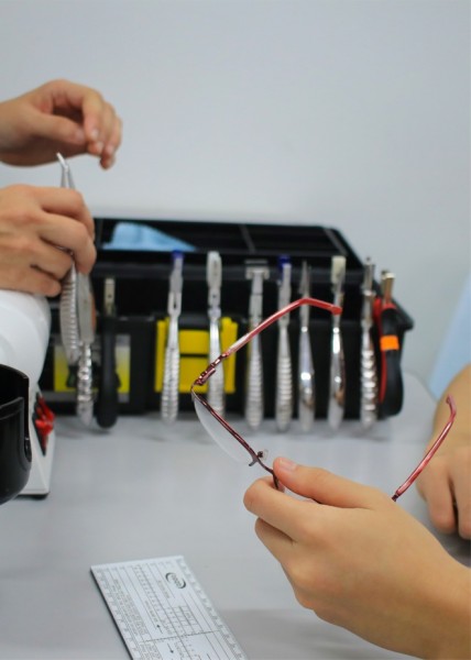 英国配镜与验光师课程的学生在实践课中学习如何正确校配眼镜。